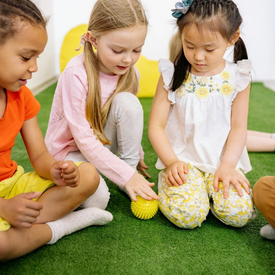 pexels-photo-8613310-8613310 Young children of diverse backgrounds playing indoors with a ball.